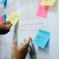 person holding yellow sticky notes